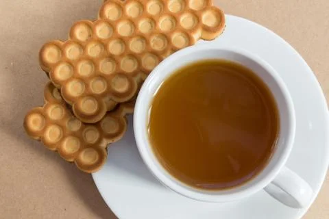 White cup of tea with biscuits Stock Photos