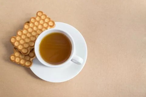 White cup of tea with biscuits Stock Photos