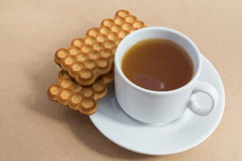 White cup of tea with biscuits Stock Photos