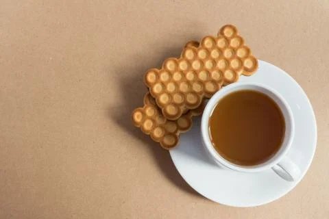 White cup of tea with biscuits Stock Photos