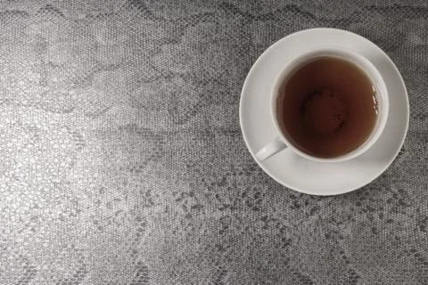 White cup with tea on a black background. Top view. Stock Photos
