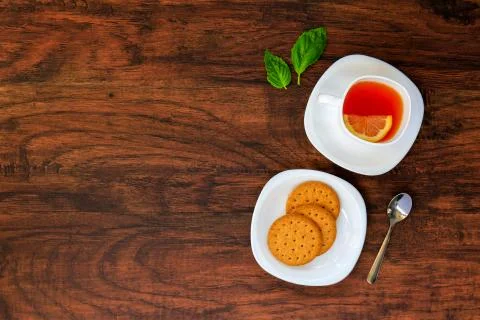 White Cup of tea with Dry cracker cookies served with a small spoon on a wood Stock Photos