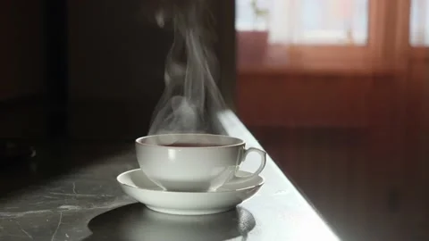 White cup of tea with hot aromatic tea, which gives off wonderful steam. Stock Footage 150350033