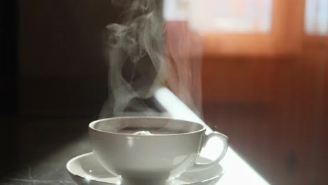 White cup of tea with hot aromatic tea, which gives off wonderful steam. Stock Footage 150445953
