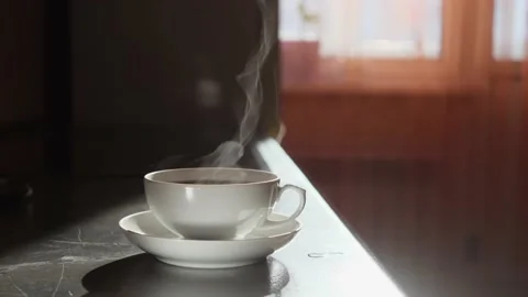 White cup of tea with hot aromatic tea, which gives off wonderful steam. Stock Footage 150569243