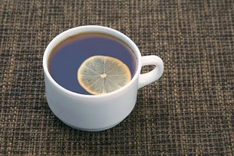 White cup of tea with lemon Stock Photos