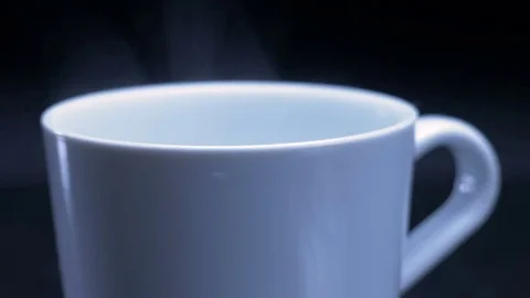 White cup of tea or coffee with steam on black background. Right side. 4K Video stock 81268369