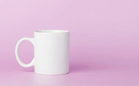 White cup for tea or coffee on a pink background Foto stock