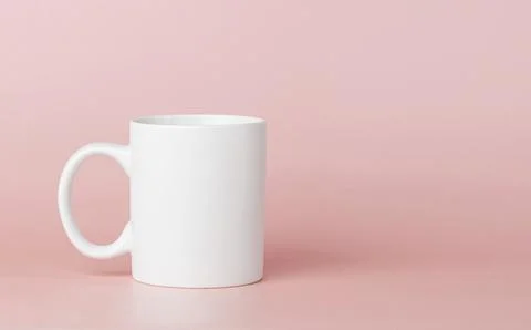 White cup for tea or coffee on a pink background Stock Photos