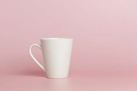 White cup for tea or coffee on a pink background Stock Photos