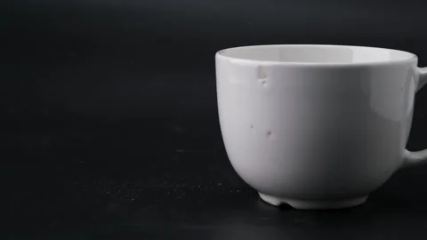 White cup for tea or soup with cracks by hammer blow on black background. Stock Footage 248503746