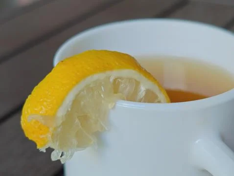 White cup of tea on the table macro photography Stock Photos
