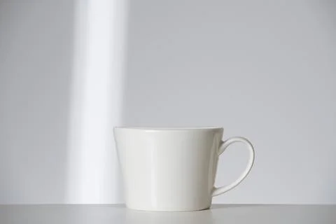 White cup on white background with ray Stock Photos