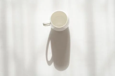 White cup on a white background with a shadow Stock Photos
