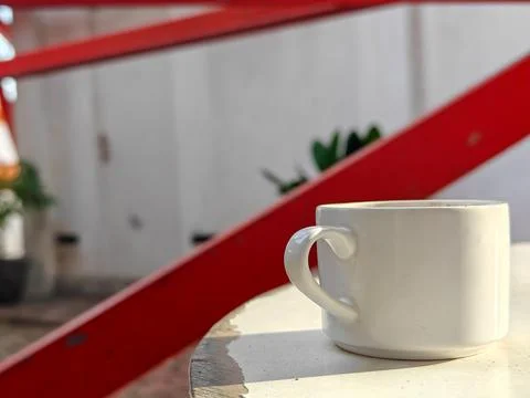 White cup on white table with blurred background Stock Photos