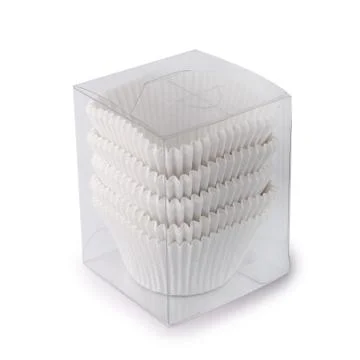 White cupcake paper forms in a plastic box isolated over white background Stock Photos