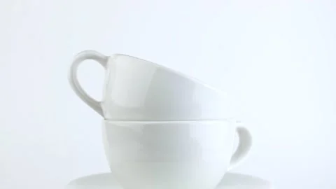 White cups rotate on a white background. Dishes for a cafe or restaurant.  Stock Footage 168420131