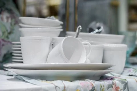 White cups with spoons on plates Stock Photos
