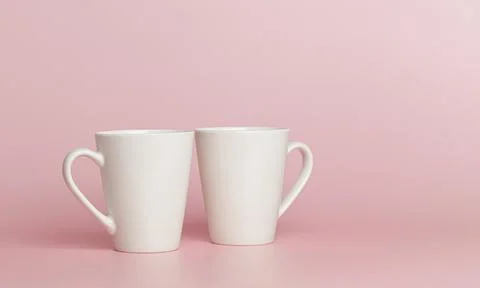 White cups for tea or coffee on a pink background Stock-Fotos