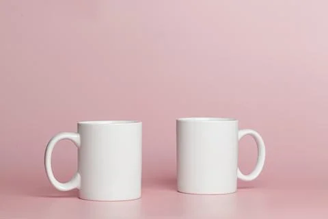White cups for tea or coffee on a pink background Stock Photos