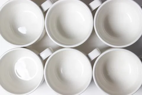 White cups on a white background. Stock Photos