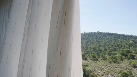 White curtain on open window, gently moved by the wind. Through the window seen Stock-Footage 129708383