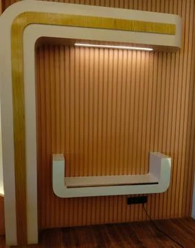 White curved shelf mounted on a vertically paneled Stock Photos