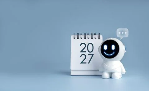 White cute friendly chatbot robot beside new year 2027 desk calendar with c.. Stock Photos
