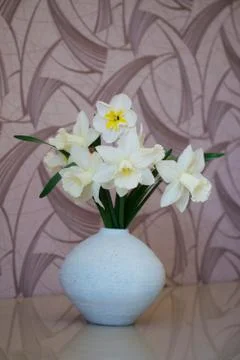 White daffodils in a vase on a table Stock Photos