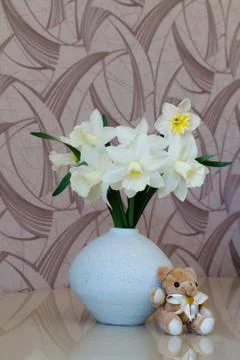 White daffodils in a vase on a table Stock Photos
