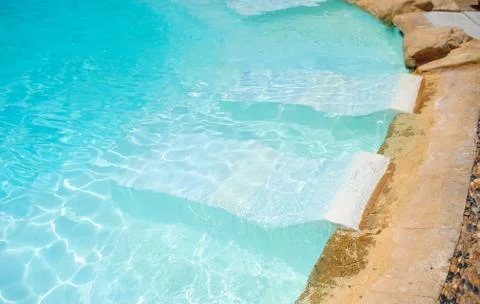 White deck chairs in the pool Stock Photos