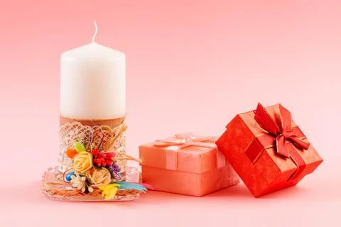 White decorated candle with two gift boxe Stock Photos