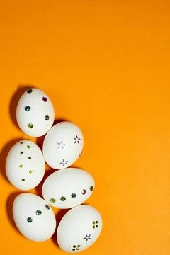 White Decorated Easter Eggs on Bright Orange Background Foto stock