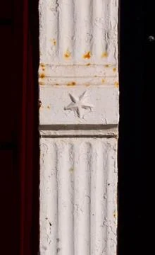 White decorated metal support element on nineteenth century brick building, v Stock Photos
