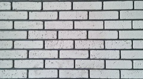 White decorative brick wall texture with porous surface and horizontal tile Stock Photos