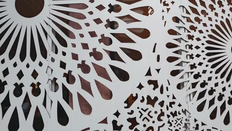 White decorative panels with circular pattern gently swaying in the breeze Stock Footage 310299400