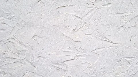 White decorative plaster wall texture with uneven rough surface and abstract Stock Photos