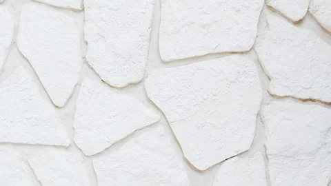 White decorative stone wall texture in close-up. Natural stone surface 動画素材 331441714