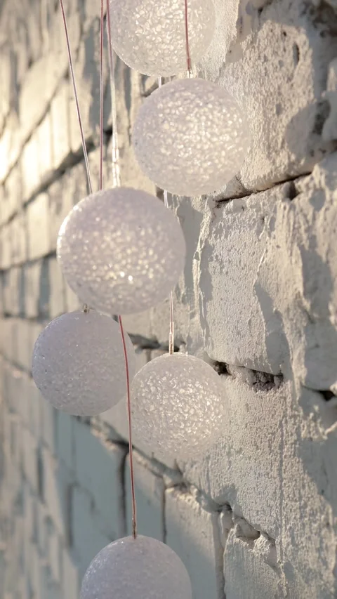 White decorative string lights on brick wall in vertical video Stock Footage 316478592