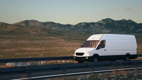 White delivery van driving along a desert road into the sunset Stock Footage 104161484