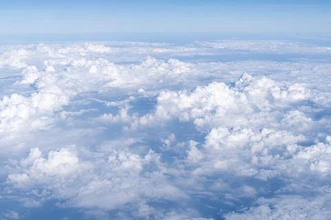 White dense clouds in a blue sky like a blown-up view from above from an Stock Photos