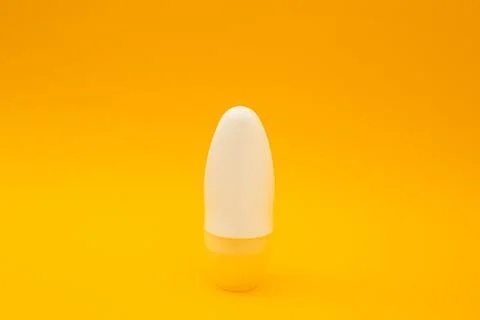 White deodorant on orange background Stock Photos