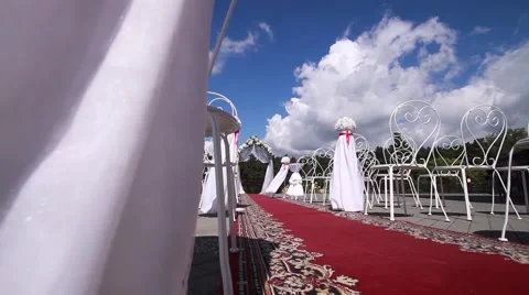 White design wedding ceremony, a red carpet. A bright Sunny day, blue sky. Stock Footage 65336831