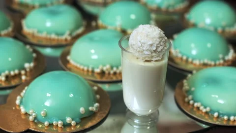 White dessert with coconut stands on a background of turquoise cupcakes Stock Footage 132143848