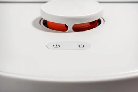 A white device with a red button on the top Stock Photos