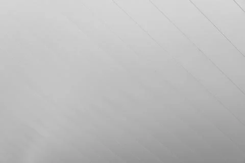 White diagonal line pattern on even gray surface. Stock Photos