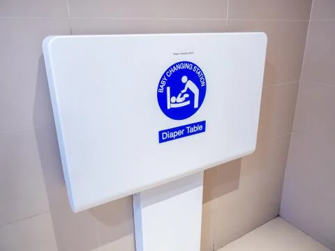 White diaper table changing station on the wall for baby changing diaper in t Stock Photos