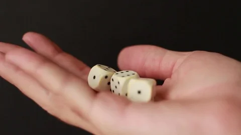 White dice in hand on black background 動画素材 75827478
