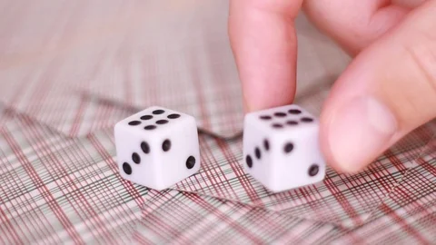 White dice on playing cards closeup Stock Footage 98480401
