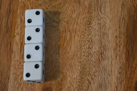 White dice showing two pips on a wooden surface 스톡 사진